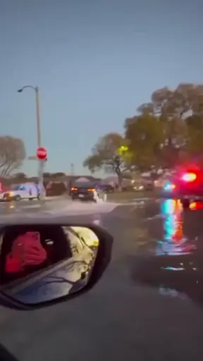 A car is lifted by water pressure from a hydrant it ran over.